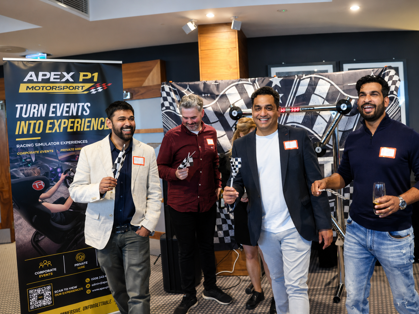 Axcel Group guests posing with Apex P1 Motorsport event setup