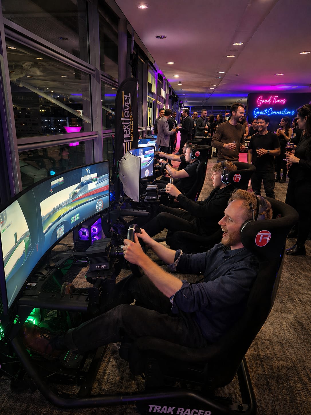 Guests racing on simulators at a black-tie event